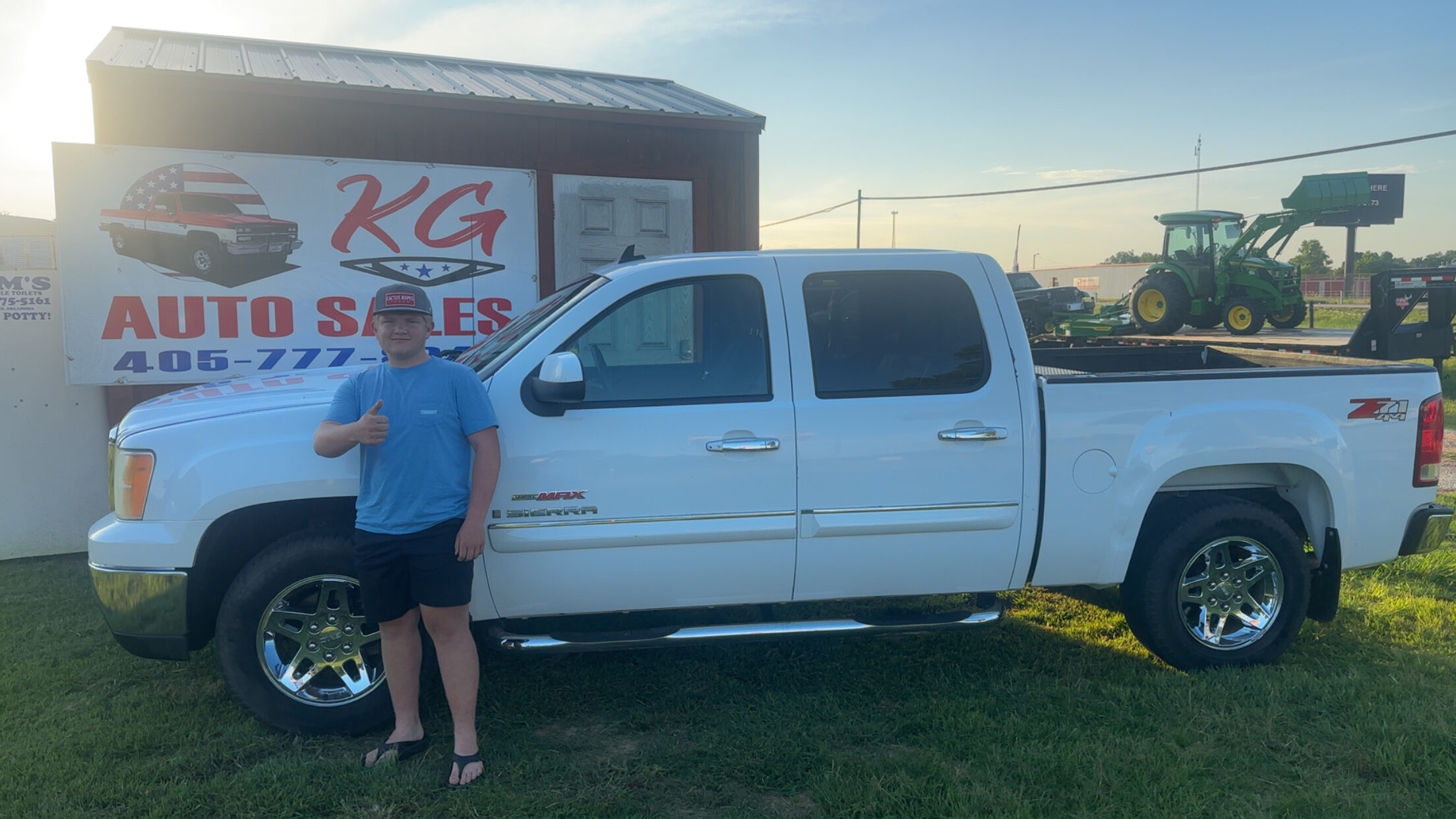 Happy customer poses with their vehicle purchased at KG Auto Sales lot.