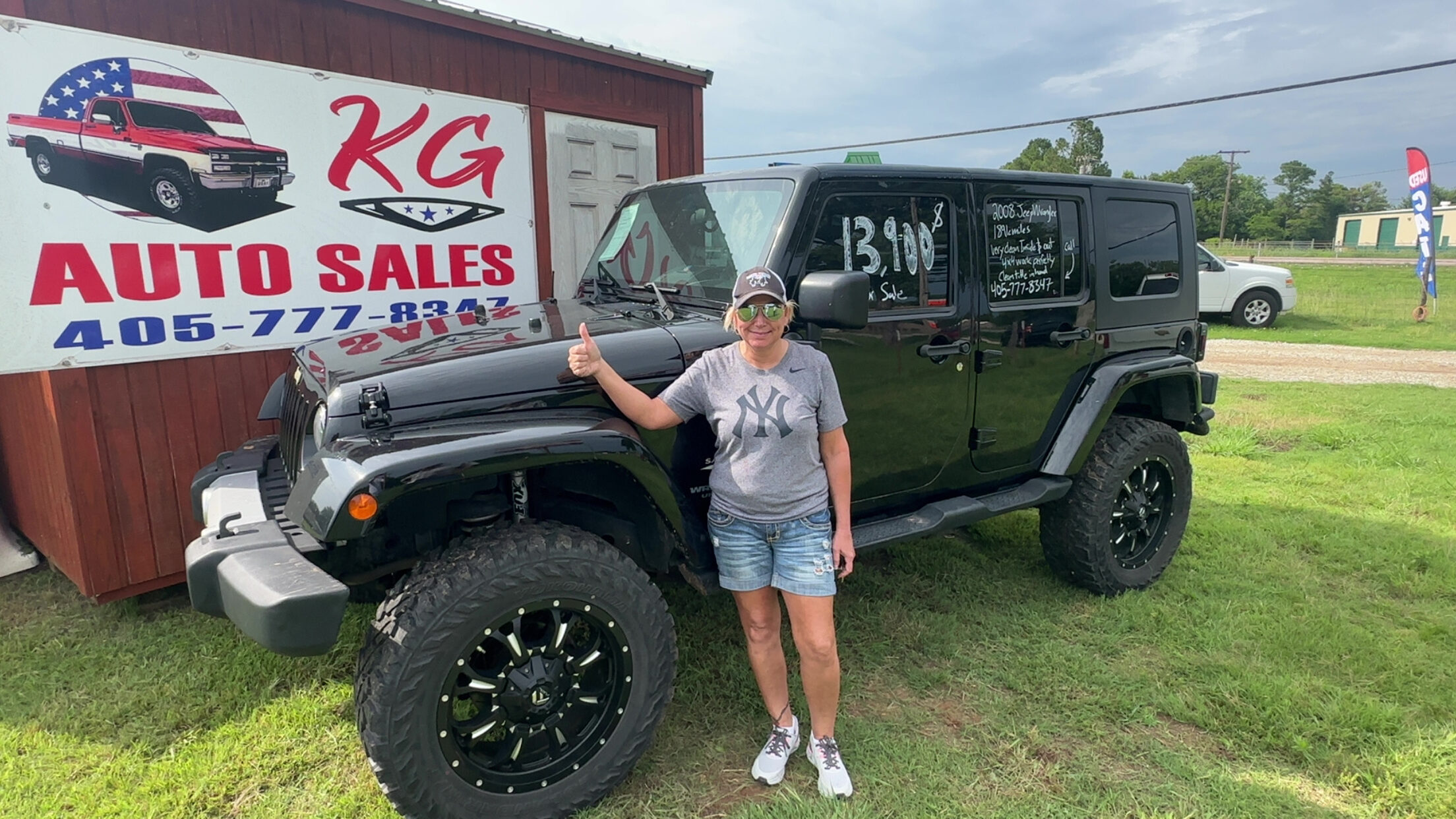 Happy customer poses with their vehicle purchased at KG Auto Sales lot.