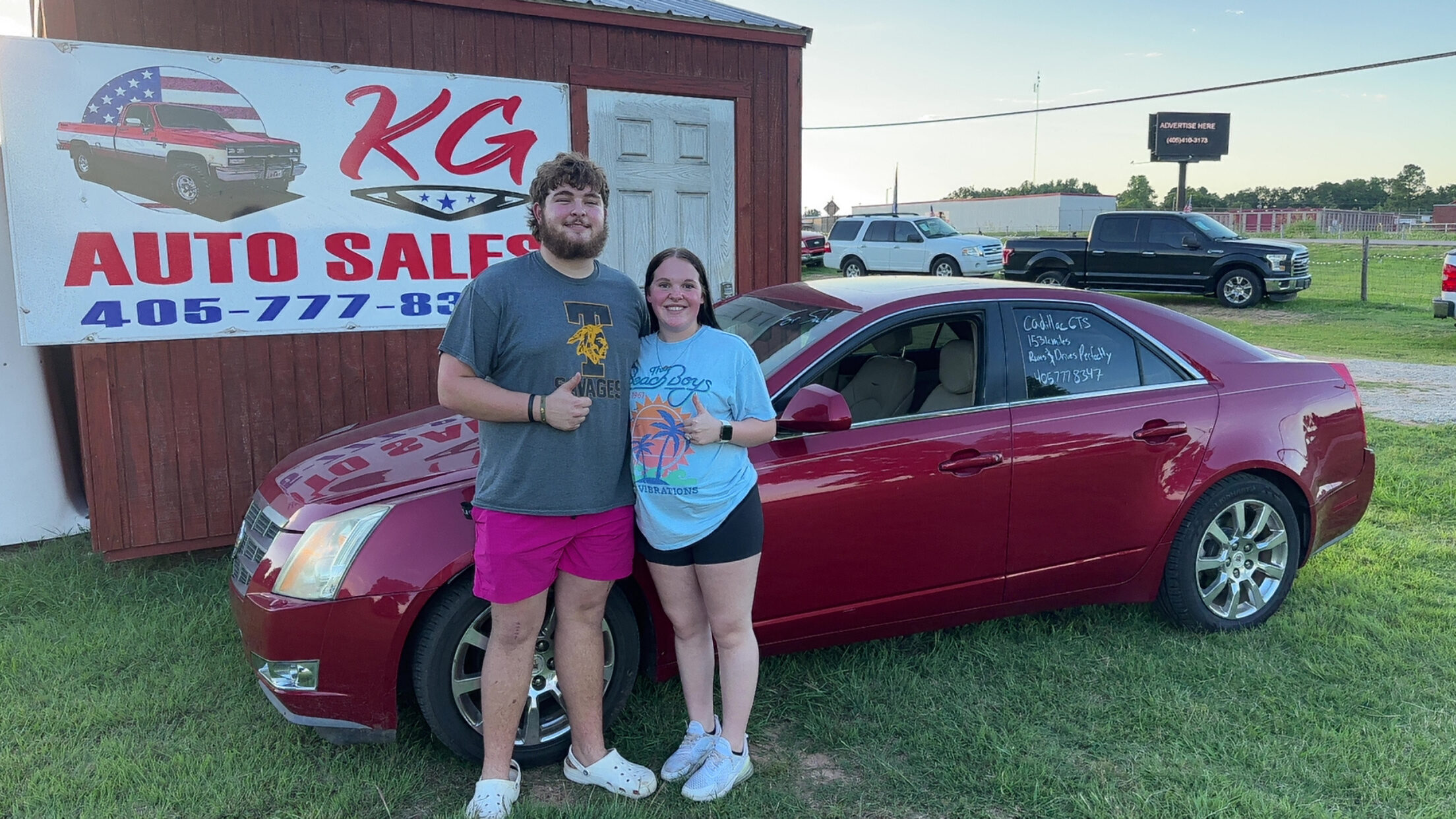 Happy customer poses with their vehicle purchased at KG Auto Sales lot.