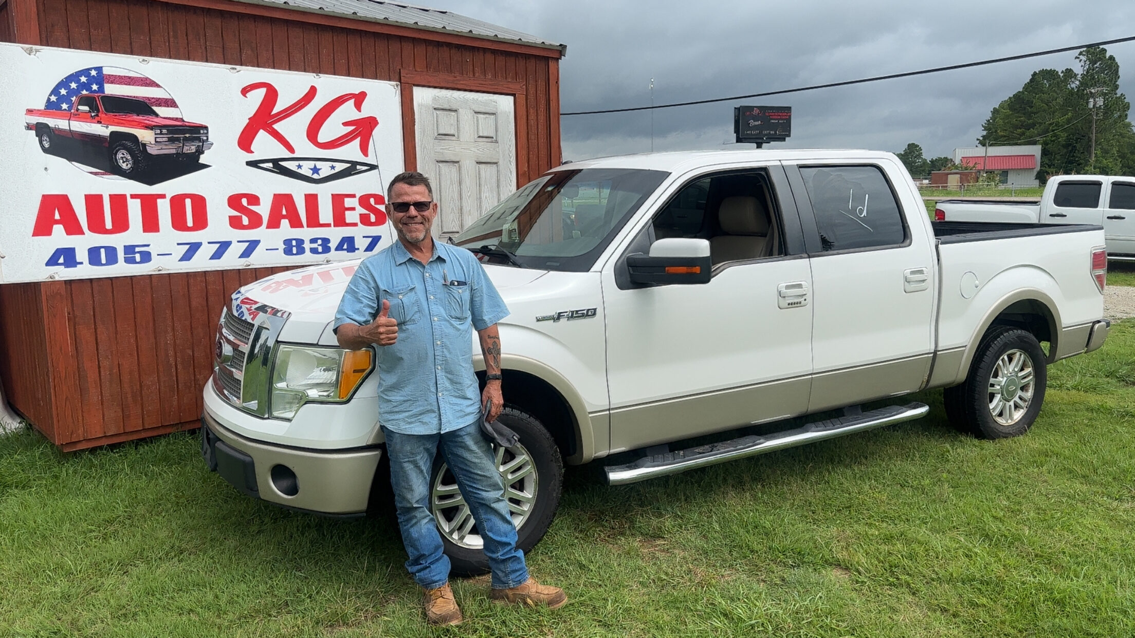 Happy customer poses with their vehicle purchased at KG Auto Sales lot.